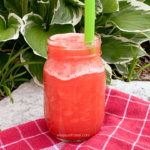 watermarked frozen watermelon lemonade in a ball jar with a straw