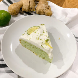 slice of lime ginger cake with coconut cream frosting