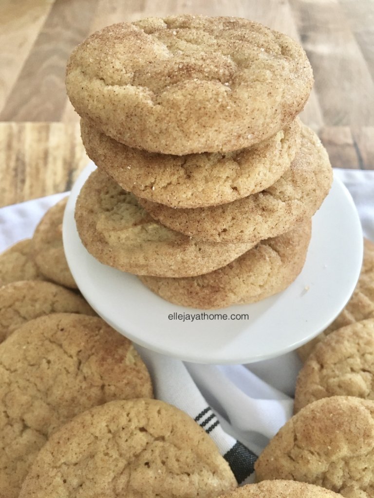 Stack of snickerdoodles on a pedestal surrounded by more snickerdoodles 