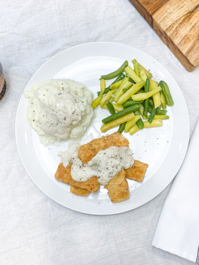 Serve chicken fried tofu with mashed cauliflower, gravy, and green beans