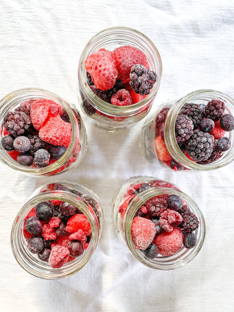 Top view of 5 jars of berry chia overnight oats arranged as a star