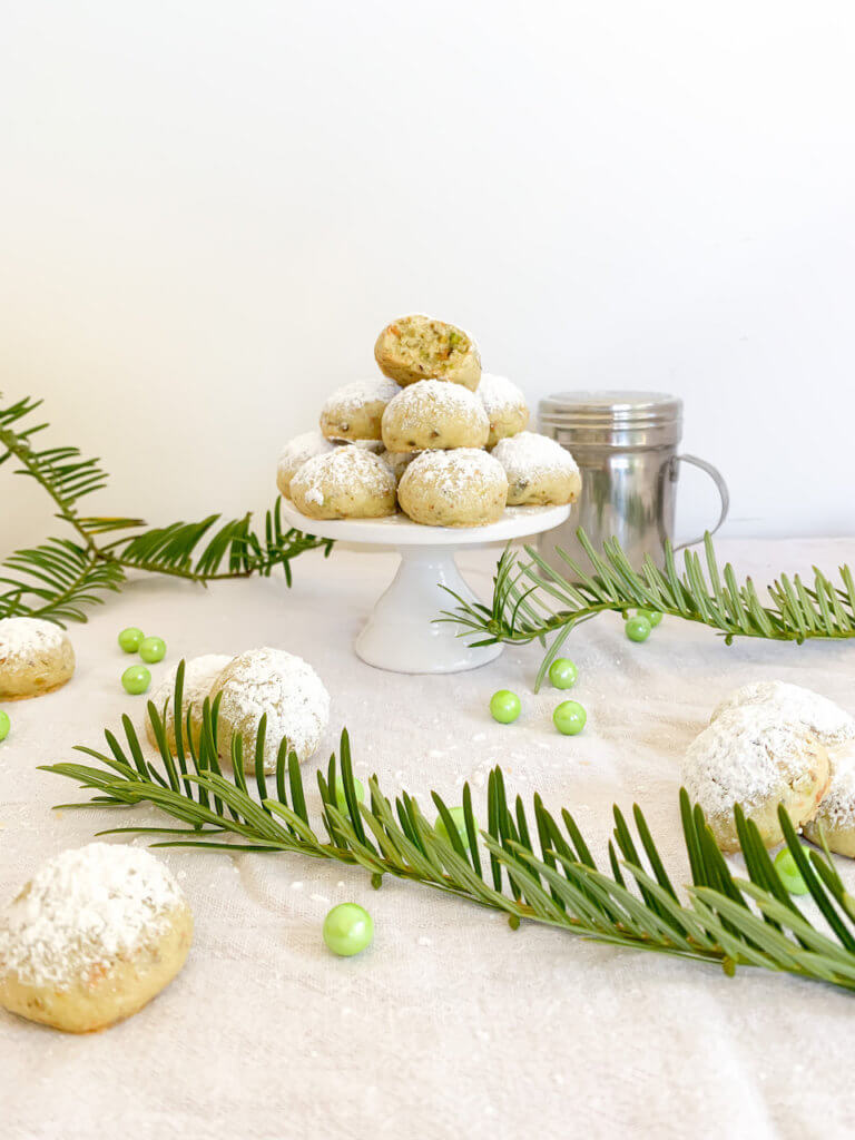 pyramid of pistachio snowballs to look like a snowy christmas tree with yew and green pearl sprinkles around