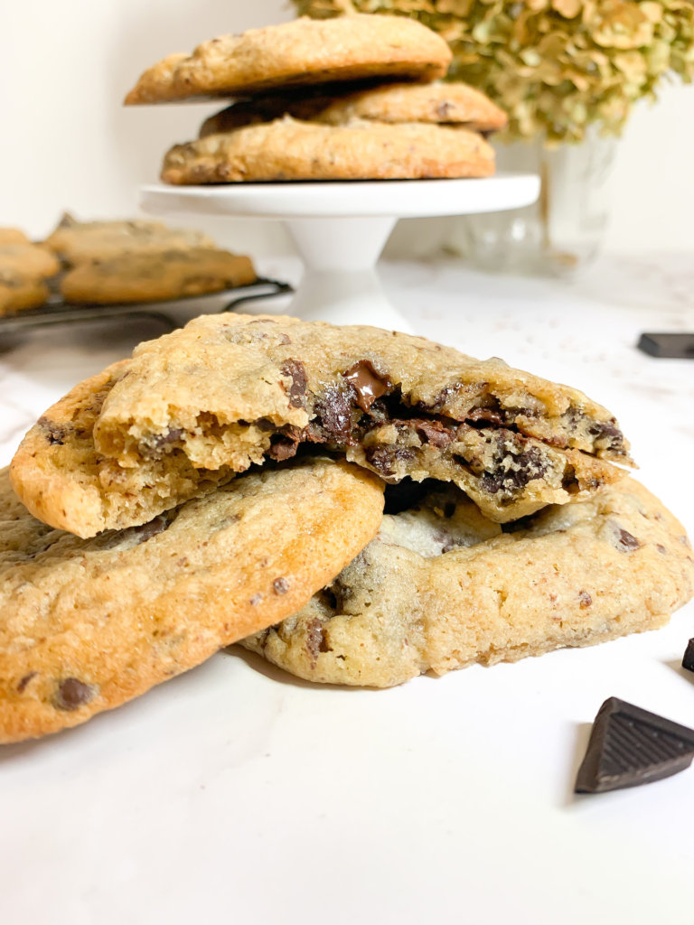 Broken open Sourdough Chocolate Chip Cookies with melty chocolate