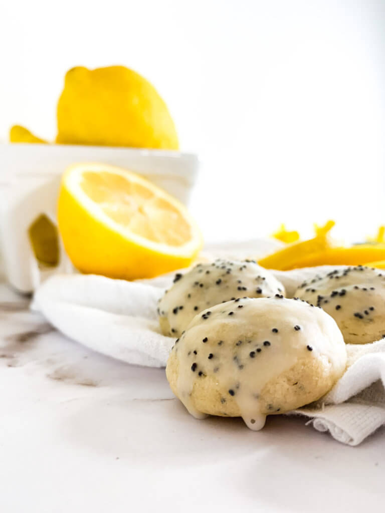 lemon poppyseed cookie with icing on a white cloth