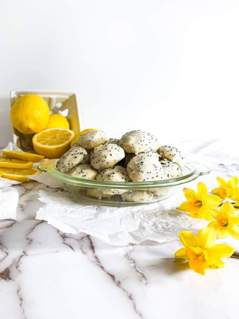 Plate of lemon poppyseed cookies with lemons and daffodils