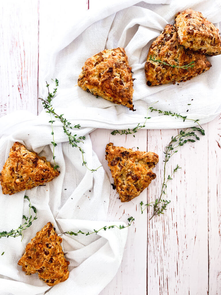 French Onion and Gruyere Scones with thyme on white linen and shiplap
