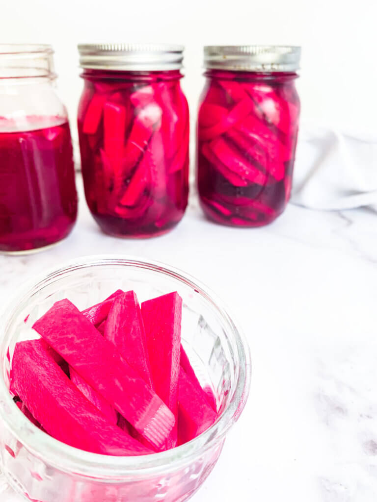 close up of vibrantly hot pink pickled turnips
