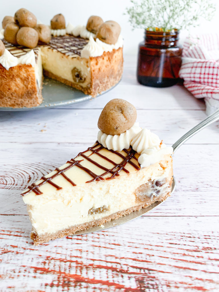close up of chocolate drizzled cookie dough cheesecake