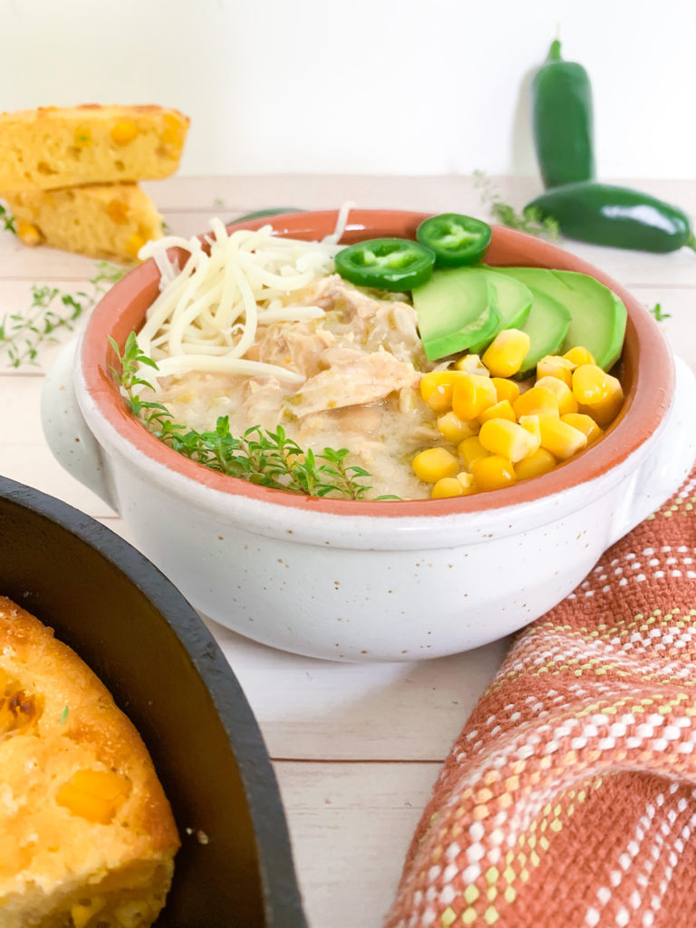 Instant Pot White Chicken Chili with cornbread and jalapenos and an orange dish towel