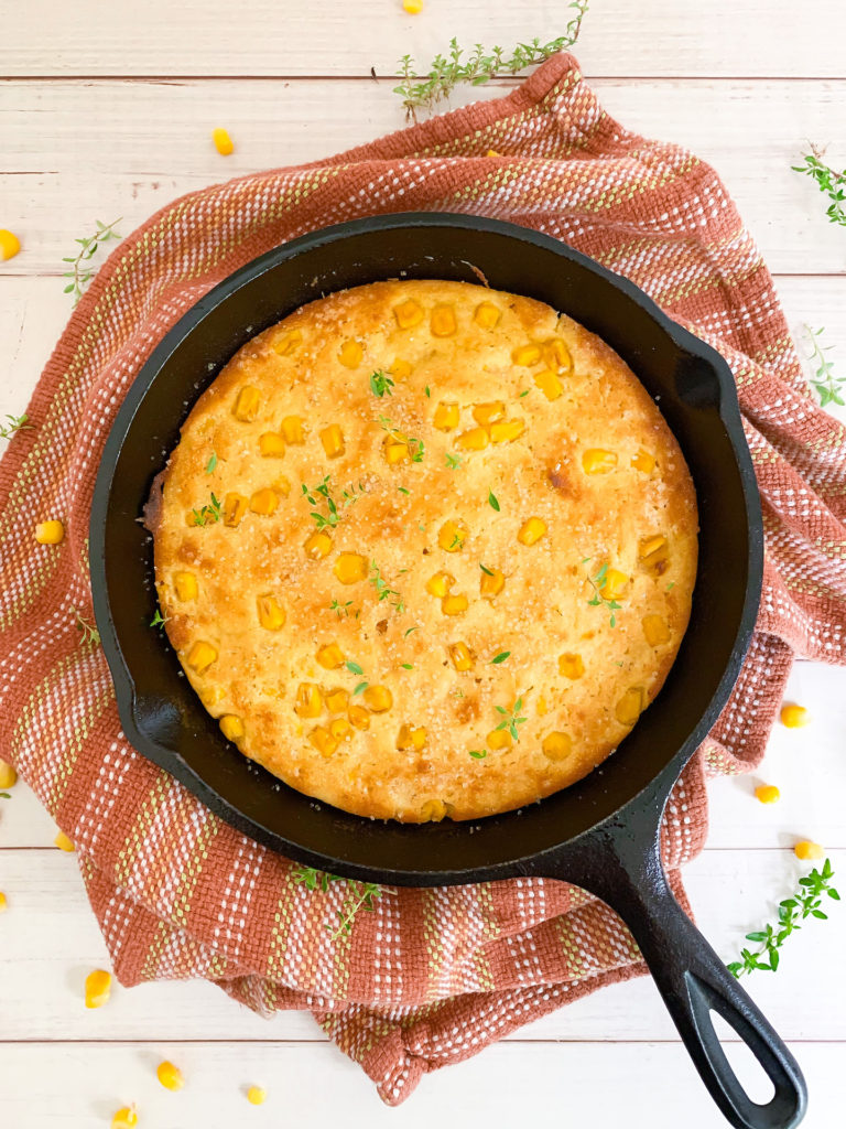 Small Batch cornbread in a 6-inch cast iron skillet topped with thyme