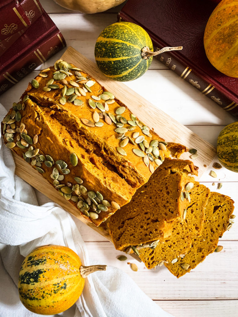 maple pumpkin bread sliced to expose dense, moist interior