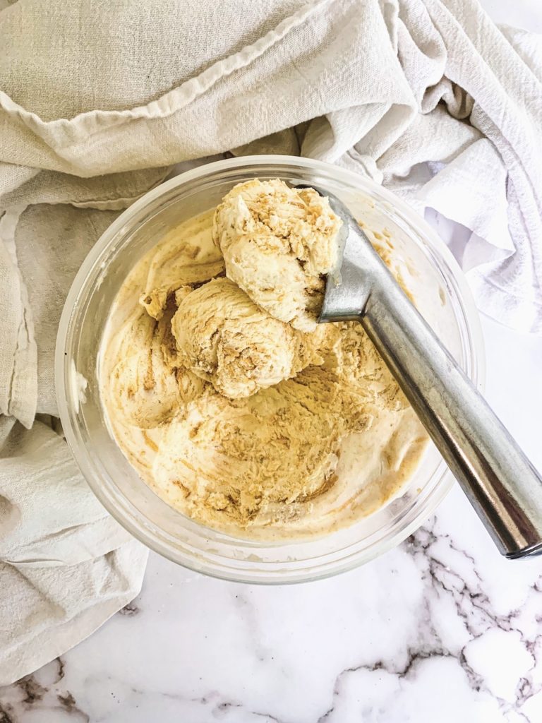Peanut Butter Swirl Ice Cream in a quart container with a silver ice cream scoop